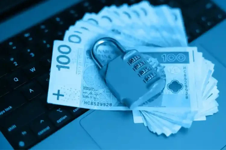 A blue-tinted image of Polish banknotes and a lock on a laptop keyboard, representing a secure automated lending platform.