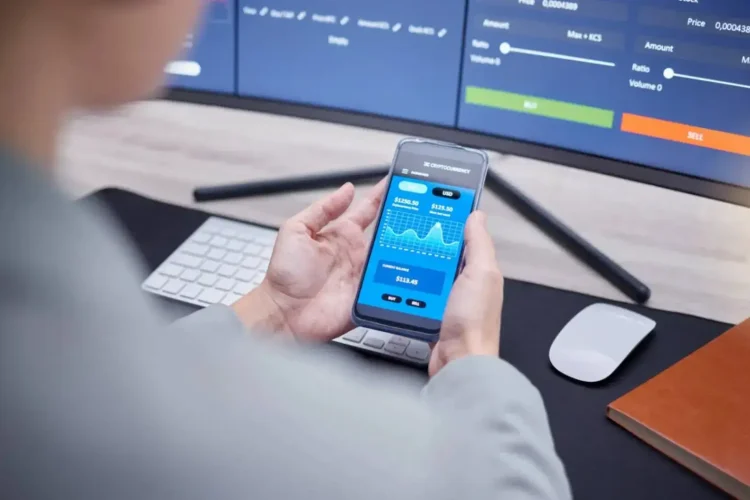 Person analyzing financial data and cryptocurrency trends on a mobile app connected to finance platforms for real-time trading.
