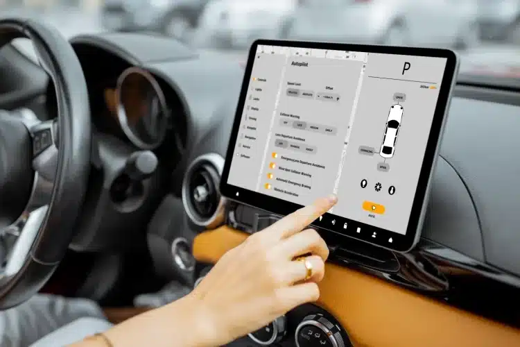 Driver interacting with a modern car touchscreen dashboard showcasing advanced automotive UI design for vehicle control and safety features.