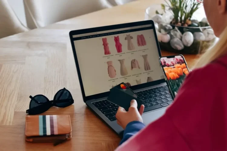 A person uses a laptop and credit card for online shopping, demonstrating an eCommerce Platform MVP.