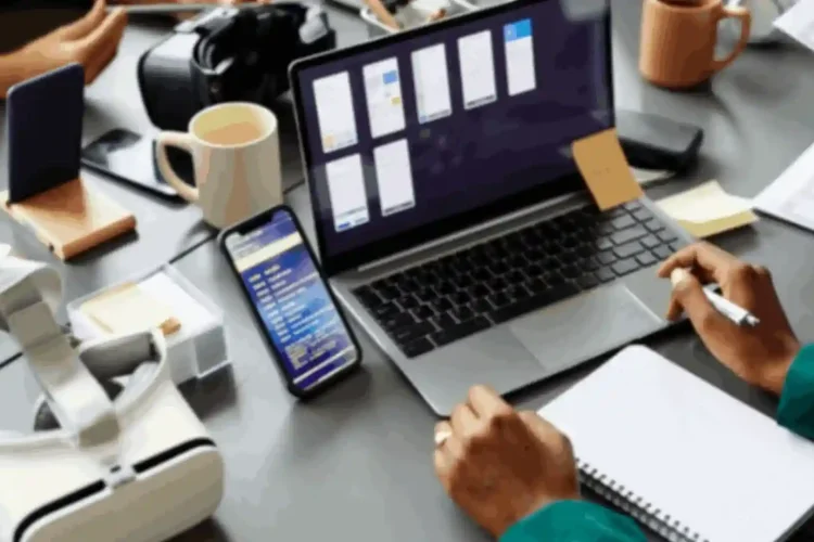 A person works on a laptop and phone, representing an internet marketing API solution.