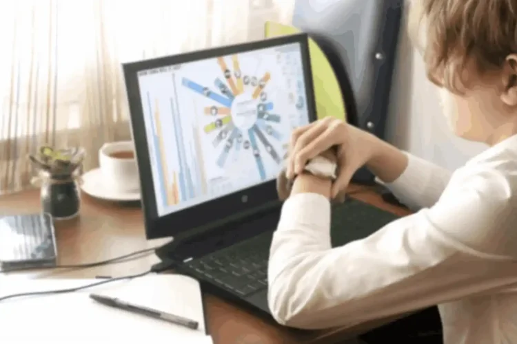 A person uses an advanced sports analytics app on a laptop, showing charts and data.