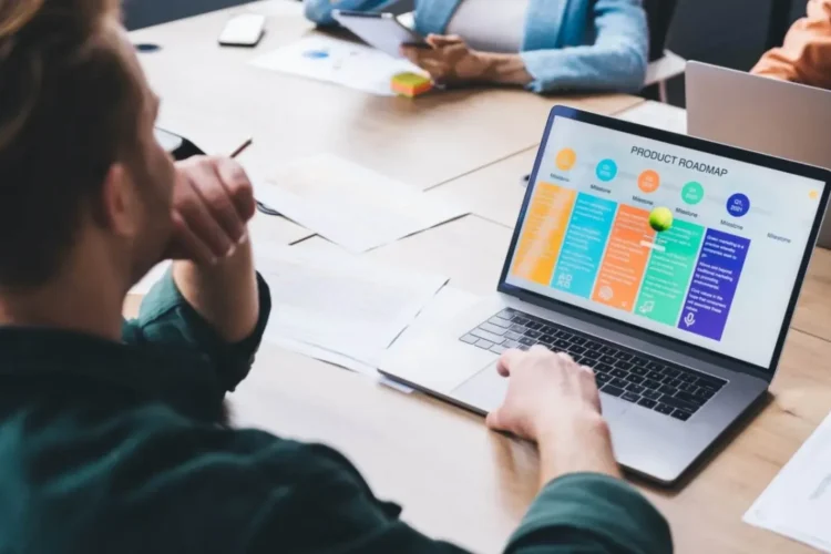 A marketing professional reviews a product roadmap on a laptop, a key component of Internet Marketing MVP.