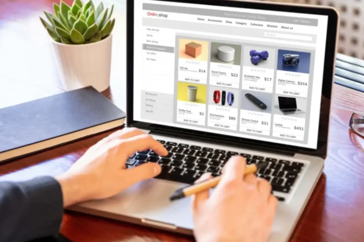 A person uses a laptop to browse an online store, powered by Enhanced eCommerce Platform Solutions.