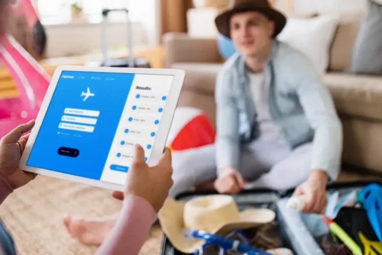 A person plans a trip on a tablet, a process supported by sports industry database development.
