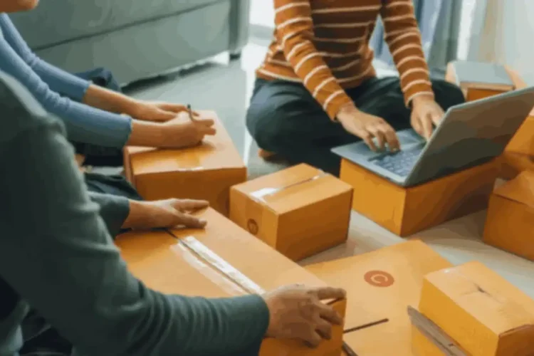Two people sitting with shipping boxes, symbolizing eCommerce Operations API integration.