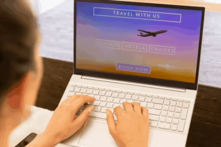 A person uses a travel agency app solution on a laptop to book flights and hotels.